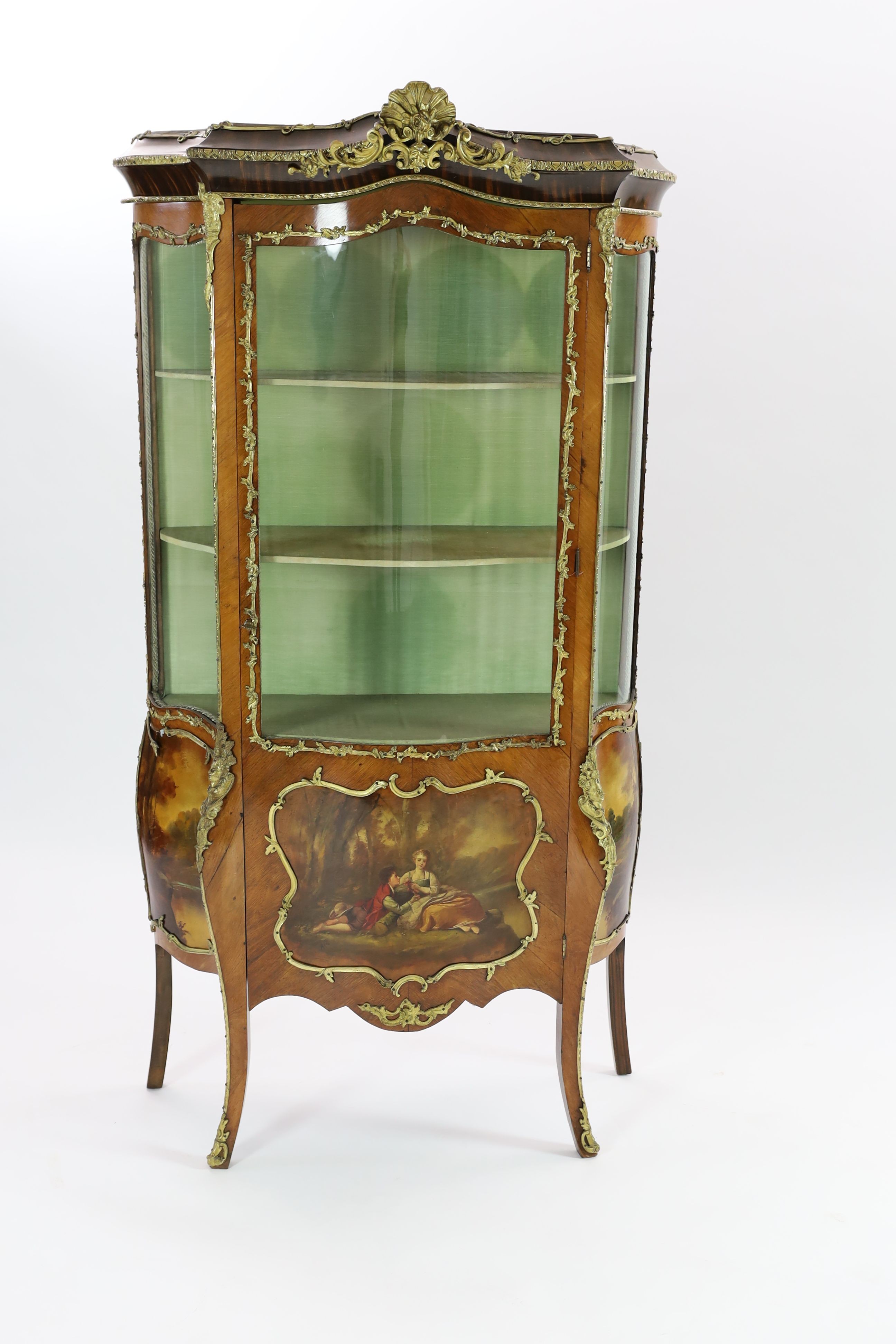 A French gilt metal mounted kingwood serpentine vitrine, W.108cm D.36cm H.193cm